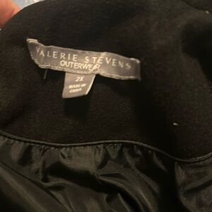 This is a Valerie Steven’s coat. It is made of 100% polyester.